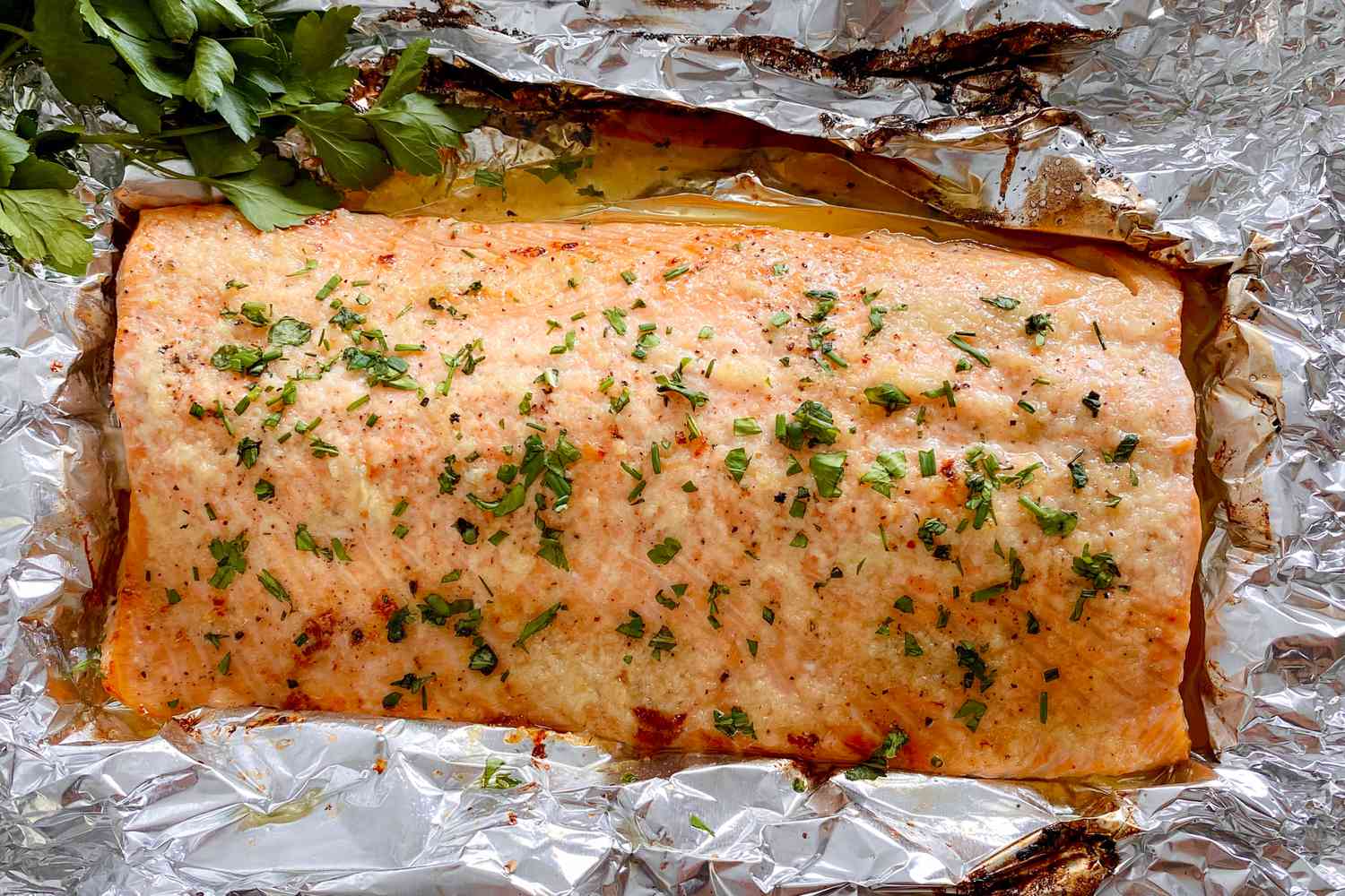 A seasoned salmon fillet placed in a baking dish, ready to be baked at 350 degrees.