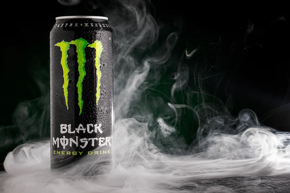 A can of Monster energy drink with the brand logo and text "Monster Energy" prominently displayed.